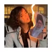 Iranian women light cigarettes with burning images of Supreme Leader in bold protest