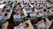 Global photos: classroom naps, migrant rescues, and wildfire threats