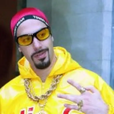 Sacha Baron Cohen surprises Wimbledon as Ali G in marijuana-themed outfit