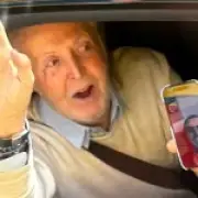 Beatles fans on Magical Mystery Tour bus spot Sir Paul McCartney on phone to Ringo Starr