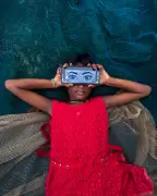 Photographer captures girl absorbed in phone beside fishing nets in West Bengal