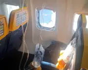 Woman saves husband from being sucked out of Ryanair plane window