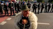 Global photos: Romania protests, Emmys, Gaza burial, rocket launch