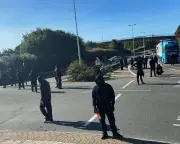 Masked protesters block Dover port road, causing major traffic delays