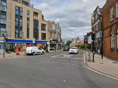 Man in 30s critical after Woolwich shooting; police hunt suspect